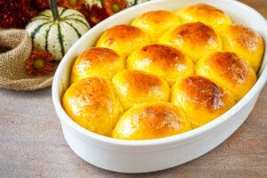 Pumpkin Yeast Rolls in a white baking dish.