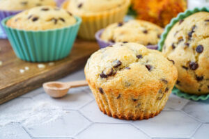 Vanilla Chocolate Chip Muffins next to a spoon with vanilla sugar.
