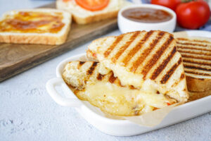 Braaibroodjie (South African Grilled Cheese Sandwich) cut in half with melted cheese.