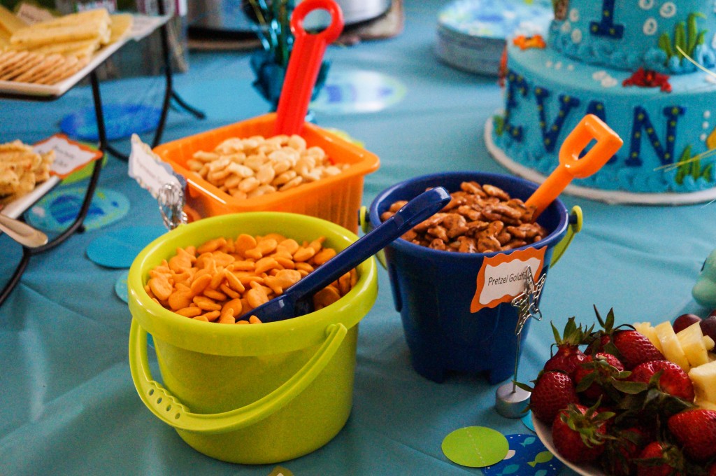 Crackers and goldfish in sand buckets with shovels.