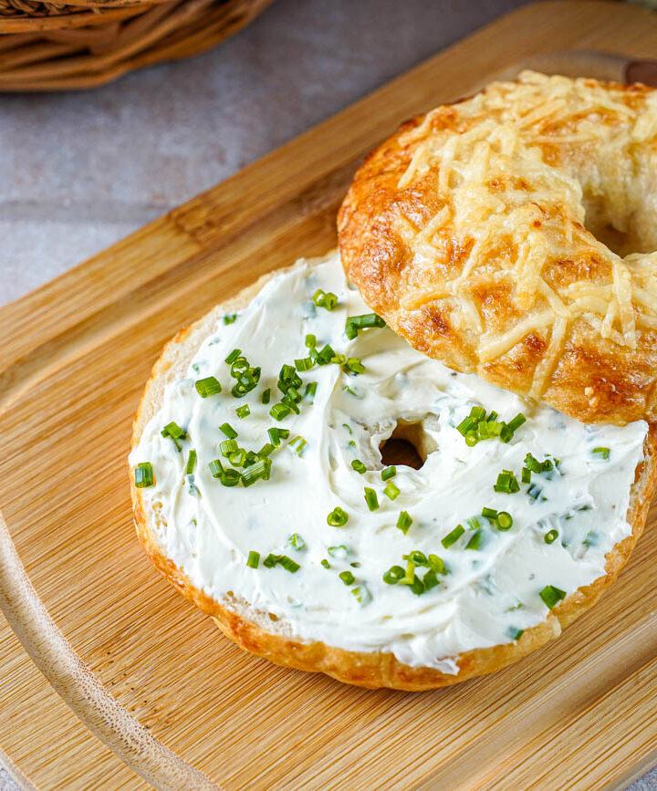 Asiago Bagel cut in half and covered with a layer of chive cream cheese.