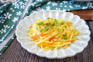 Gamja Bokkeum (Korean Stir-Fried Potatoes) on a light green plate.