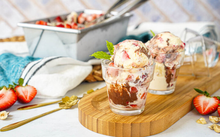 Strawberry Chocolate Hazelnut Ice Cream in two glasses with more in a loaf pan in the background.