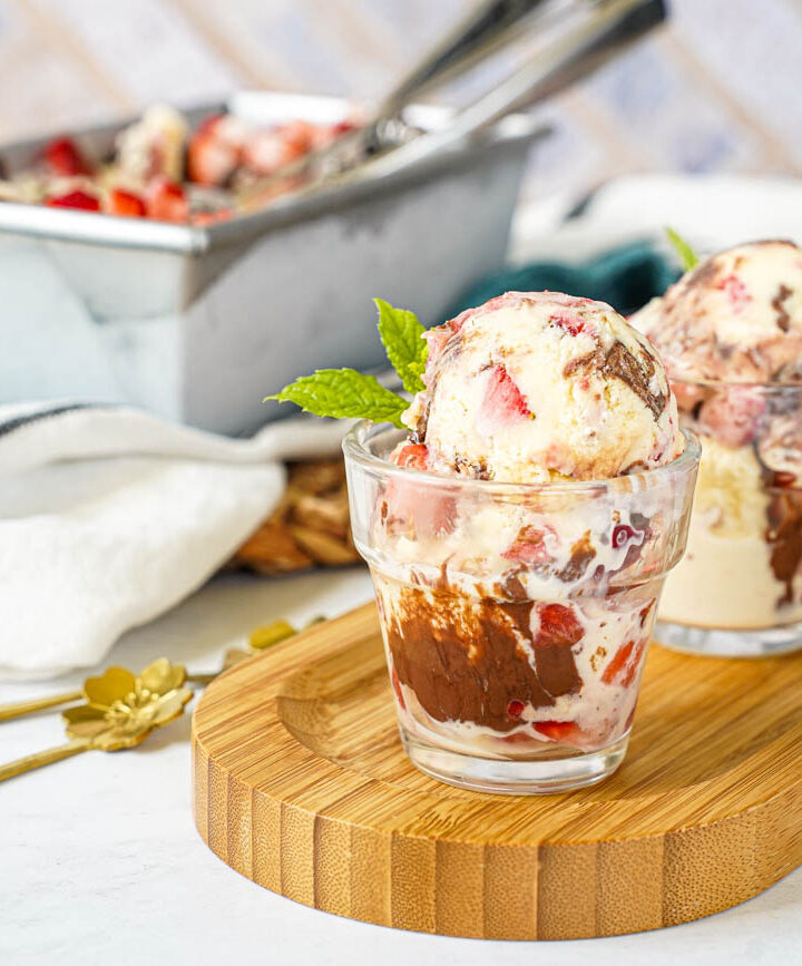 Strawberry Chocolate Hazelnut Ice Cream in two glasses with more in a loaf pan in the background.