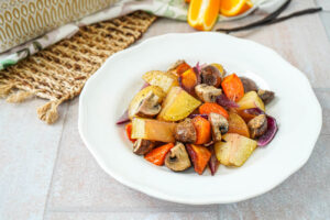 Roasted Vegetables with Orange Vanilla Vinaigrette on a white plate.