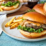 Marsala Burgers on two plates with fries.