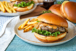 Marsala Burgers on two plates with fries.