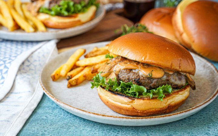 Marsala Burgers on two plates with fries.
