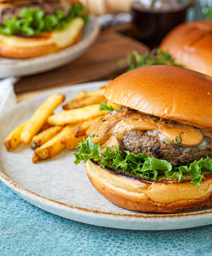 Marsala Burgers on two plates with fries.