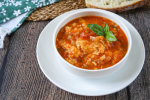 Pappa al Pomodoro (Tuscan Bread and Tomato Soup) in a white bowl over a white plate.