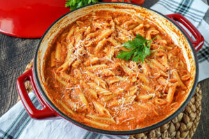 Pasta alla Vecchia Bettola (Penne in Vodka Cream Sauce) in a large red pan.