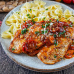 One-Pan Chicken with Cherry Tomatoes on a plate with farfalle pasta.
