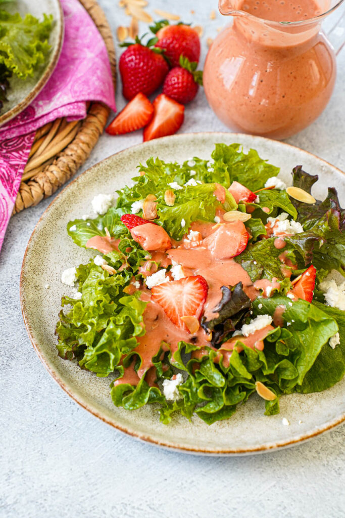 Strawberry Balsamic Vinaigrette drizzled over a plate of salad.
