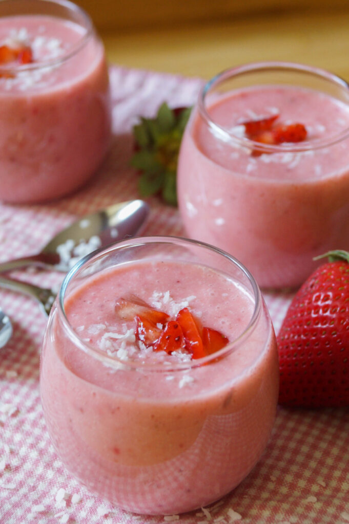 Close up of Strawberry Coconut Soup topped with diced strawberries and coconut flakes.