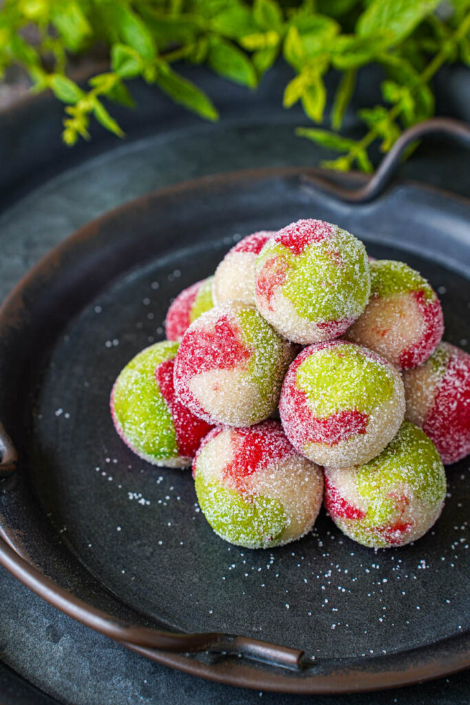 Close up of a stack of Kaber Ellouz (Tunisian Almond Balls) coated in sugar.
