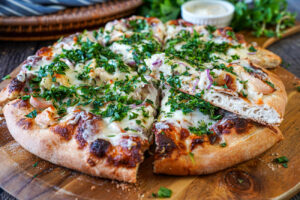 Roasted Garlic Chicken Pizza cut into slices.