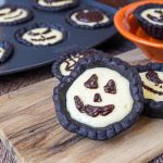 Cheesecake Tartlets with Jack o Lantern chocolate ganache faces.