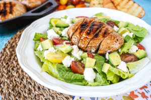 Grilled Portobello Salad with lettuce, avocado, tomato, goat cheese, and grilled mushrooms.