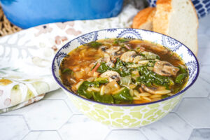 Mushroom Chard Soup in a yellow and blue bowl.