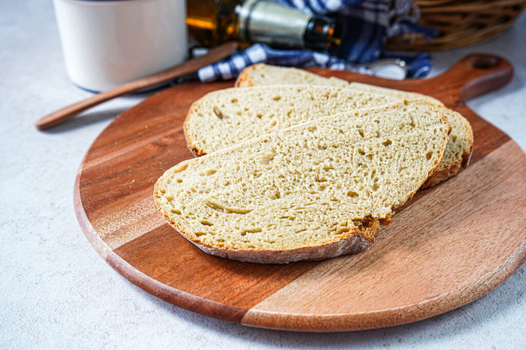 Three slices Rustic Beer Bread on a wooden board.