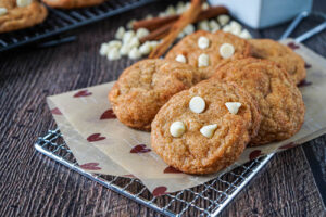 White Chocolate Snickerdoodles on a parchment lined wire rack.