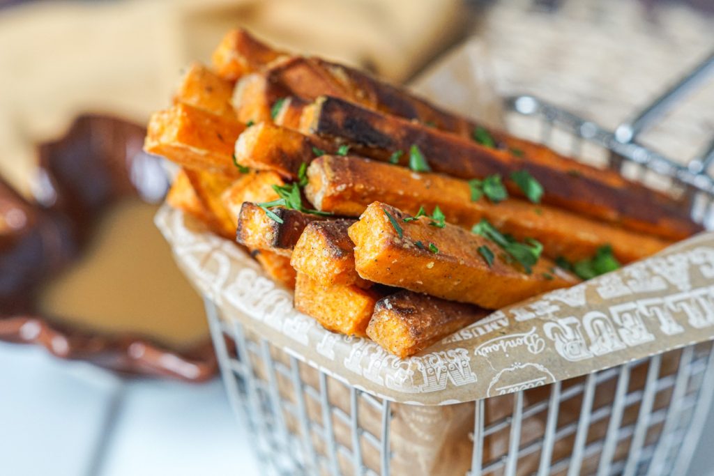 Spiced Sweet Potato Fries with Maple Mustard Dipping Sauce Spiced Sweet Potato Fries topped with salt and parsley.