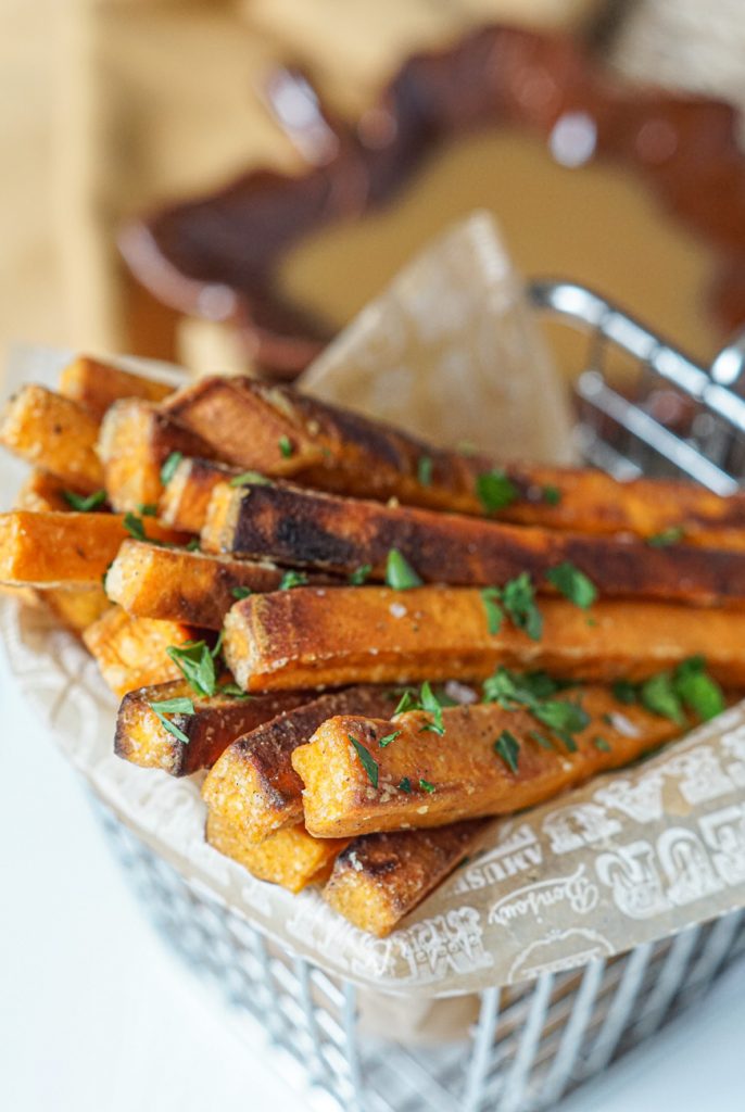 Spiced Sweet Potato Fries with Maple Mustard Dipping Sauce Close up of Spiced Sweet Potato Fries with Maple Mustard Dipping Sauce topped with parsley.