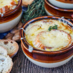 Vegetarian French Onion Soup in two brown bowls.