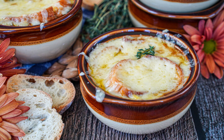 Vegetarian French Onion Soup in two brown bowls.