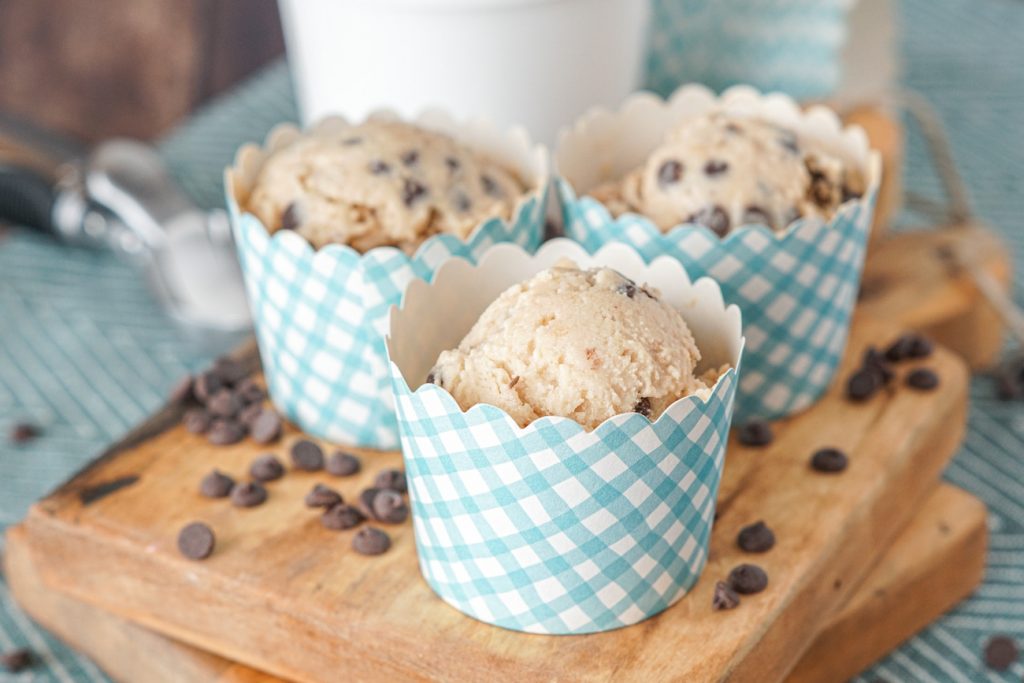 Scoops of Chocolate Chip Cookie Dough Frozen Yogurt in blue and white paper cups.