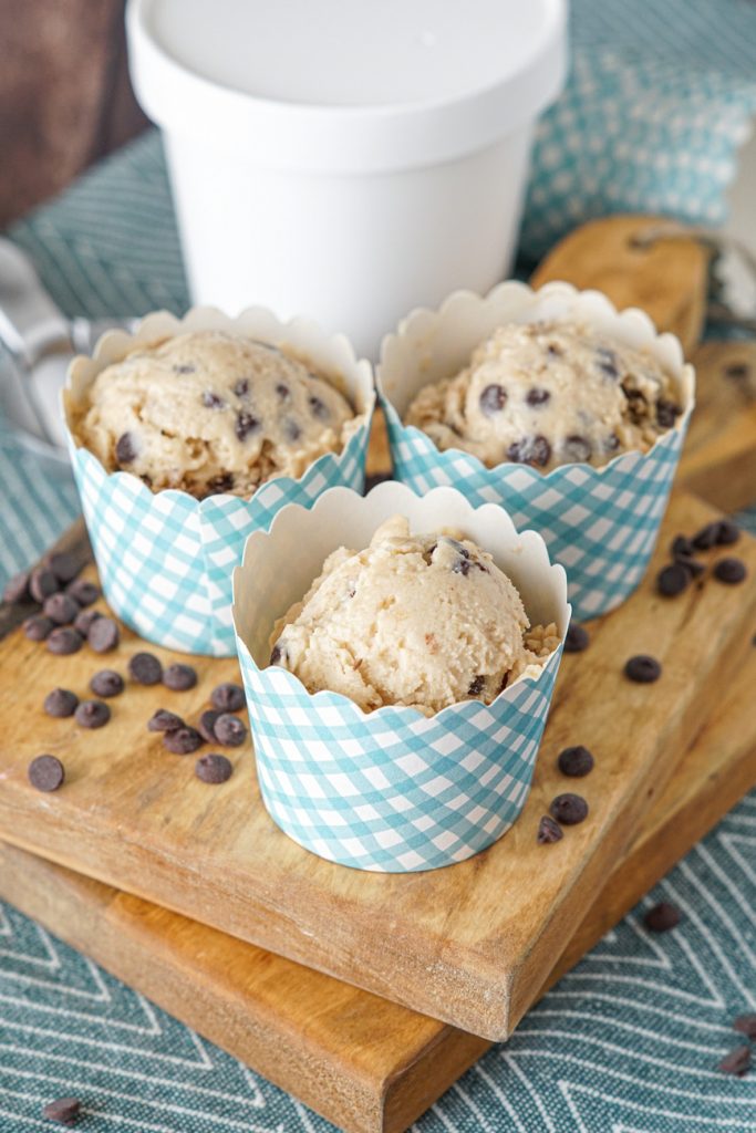 Close up of Chocolate Chip Cookie Dough Frozen Yogurt in three blue and white paper cups.