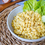 Togásos Nokedli (Hungarian Dumplings with Eggs) in a bowl with lettuce leaves.