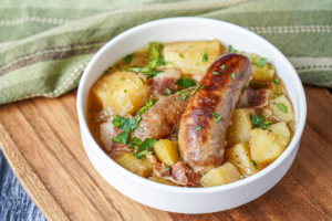 Dublin Coddle (Irish Sausage and Potato Stew) in a white bowl.