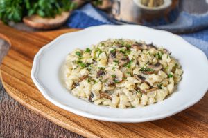 Spätzle mit Pilzen (German Spaetzle with Mushrooms) on a white plate.