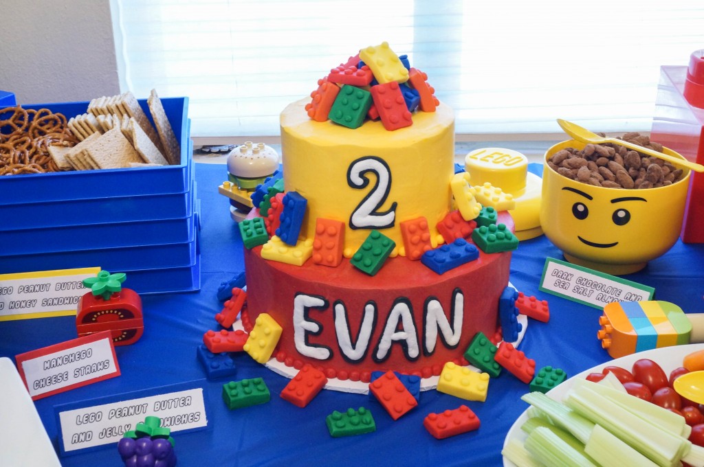 Red and yellow lego birthday cake with Evan on first tier and 2 on second tier.