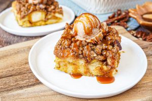 Slices of Pumpkin French Toast Casserole on two white plates.
