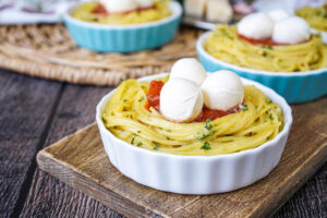Spaghetti Nests in three ramekins with fresh mozzarella balls.
