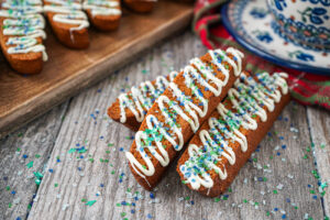 Three gingerbread biscotti next to a Polish pottery cup.