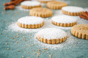 Polvorones de Aceite de Oliva (Spanish Olive Oil Cookies) covered in sesame seeds and powdered sugar.
