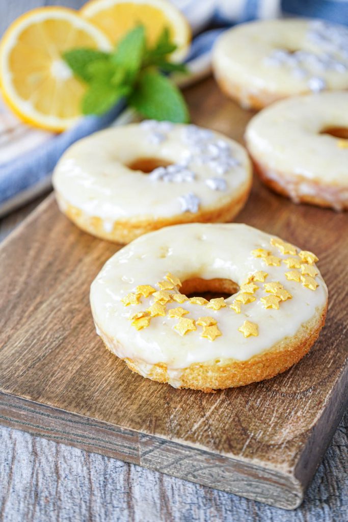 Close up of Meyer Lemon Doughnuts on a wooden board.