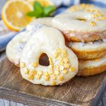 A stack of round and heart-shaped Meyer Lemon Doughnuts.