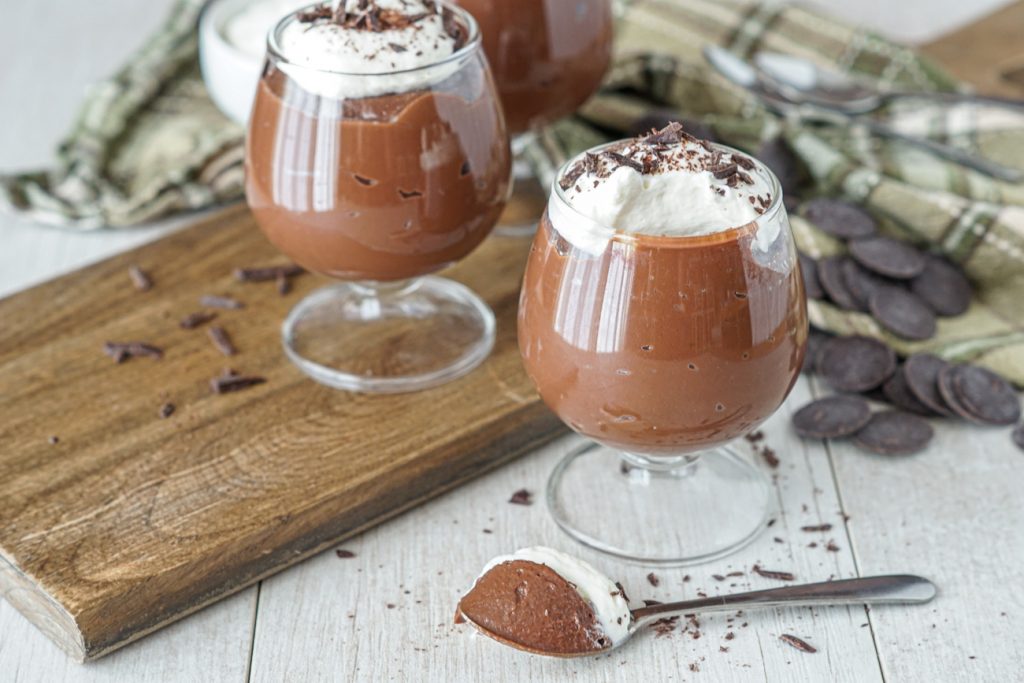 Irish Cream Dark Chocolate Pudding in small glasses and on a spoon.