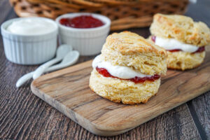 Two Irish Scones filled with butter, jam, and cream.