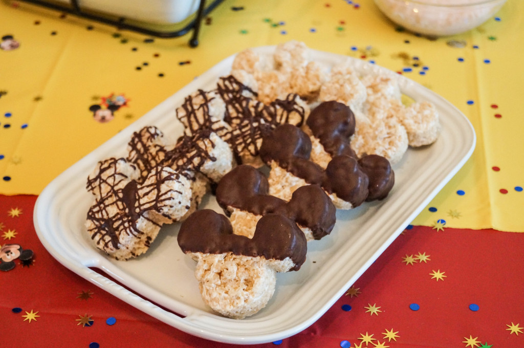Mickey Mouse Rice Krispie Treats with chocolate on a white platter.