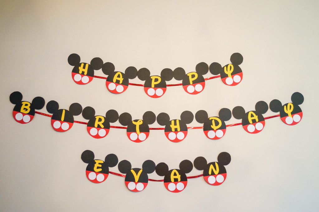 Happy Birthday Evan banner in Mickey Mouse shape.