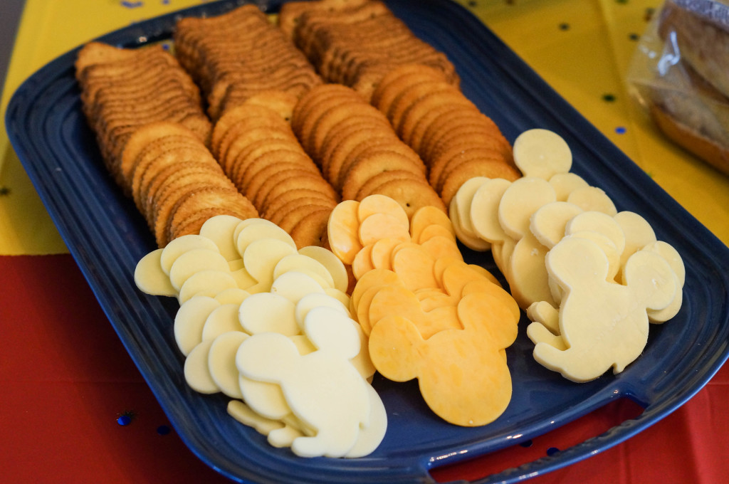 Blue platter with crackers and Mickey Mouse shaped cheese.