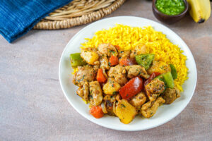 Suqaar Digaag (Somali Chicken Suqaar) on a white plate with turmeric rice.