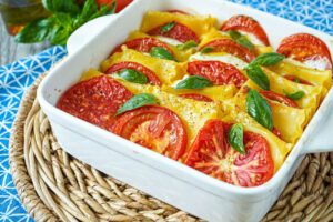 Baked Tomato Mozzarella Pasta in a square white baking dish.