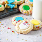 Iced Thumbprint Cookies with white, yellow, blue, and green icing.