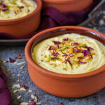 Kesar Elaichi Shrikhand in two clay bowls.